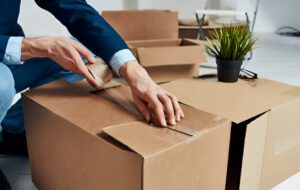 Man unpacking boxes new place emotions office manager