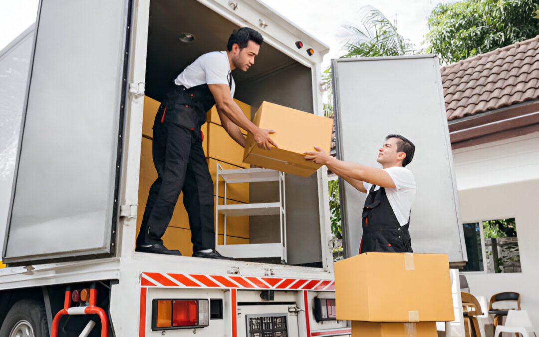 With smiling faces removal company workers efficiently unload boxes